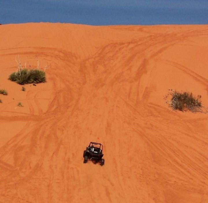 ATV riding up sand dune at Sand Hollow.
